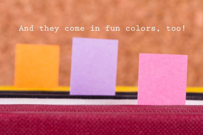 Colorful post it tag markers inside books.